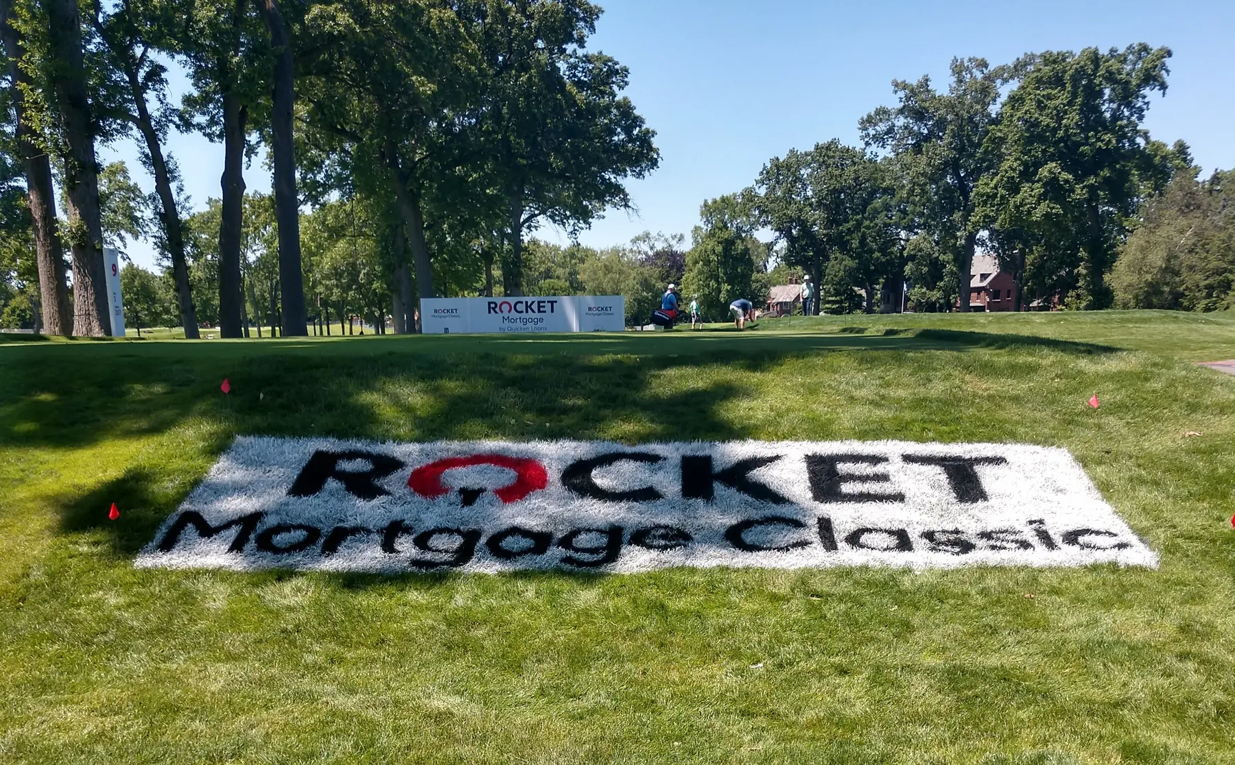 Rocket Mortgage logo painted on a golf course lawn